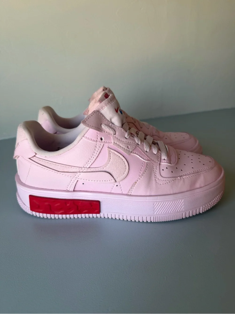 Nike Air Force 1 Women’s Light Pink Low-Top Sneakers with Red Accent